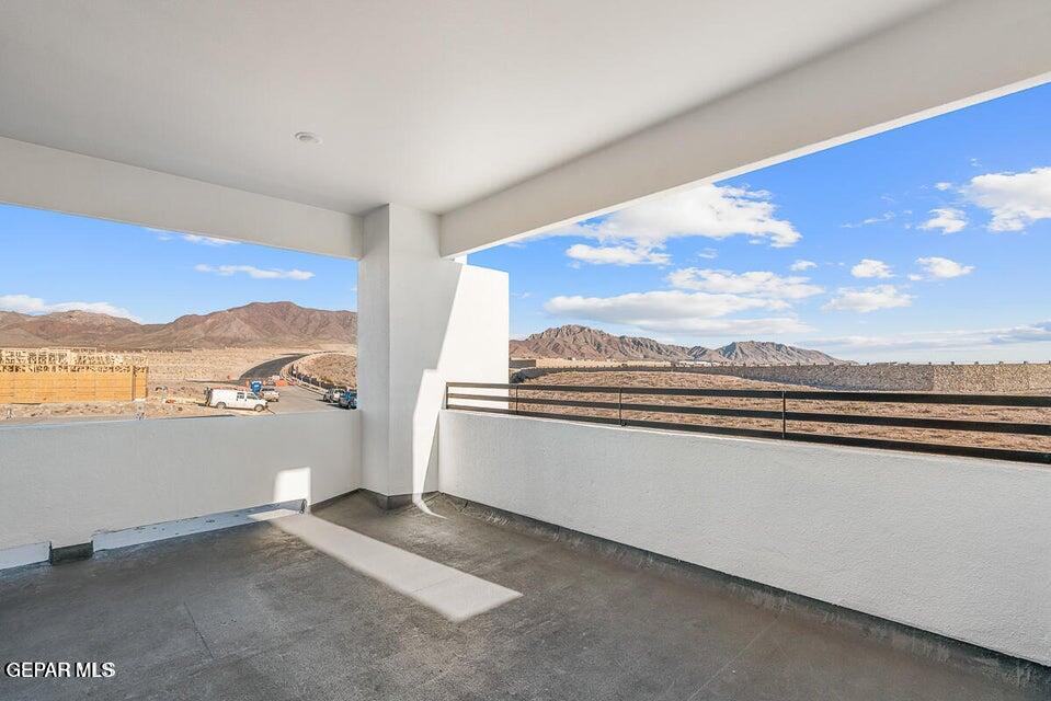 7353 Cimarron Rim Road El Paso, TX 79911 - Photo 26 of 30 a view of a living room with furniture and a floor to ceiling window