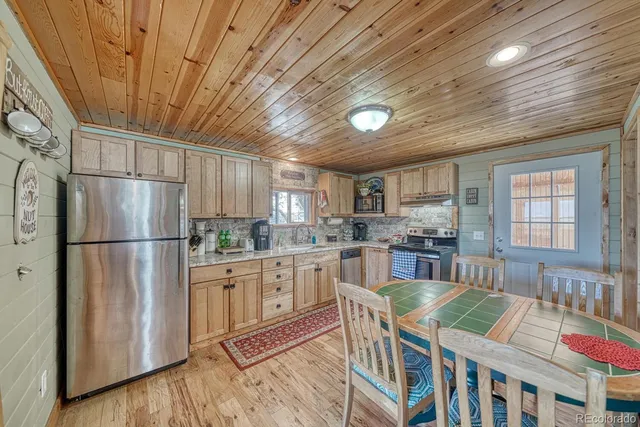 a kitchen with lots of counter top space and stainless steel appliances