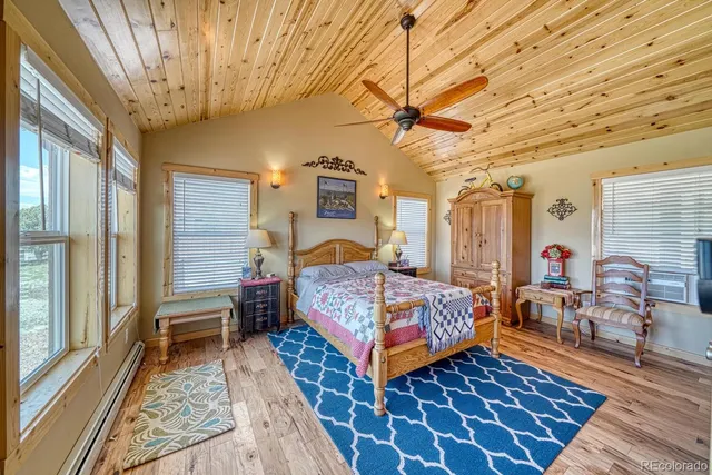 a bedroom with a bed next to a window and a chandelier