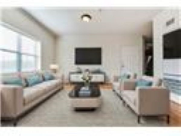 10102 Neuens Road, Unit A302 Houston, TX 77080 - Photo 2 of 8 a living room with furniture and a flat screen tv