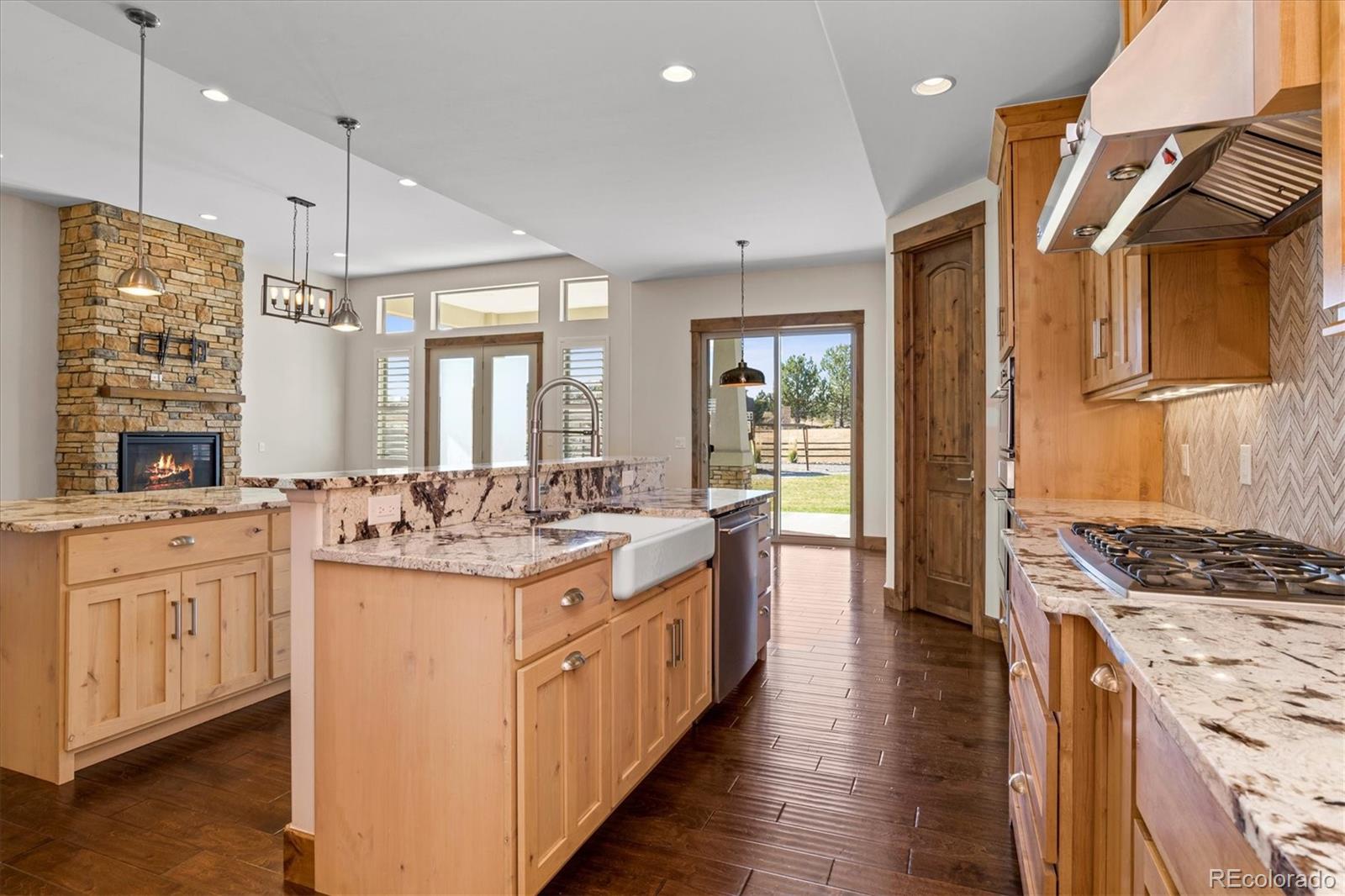 5561 Rim View Place Parker, CO 80134 - Photo 16 of 40 a kitchen with stove a sink and refrigerator
