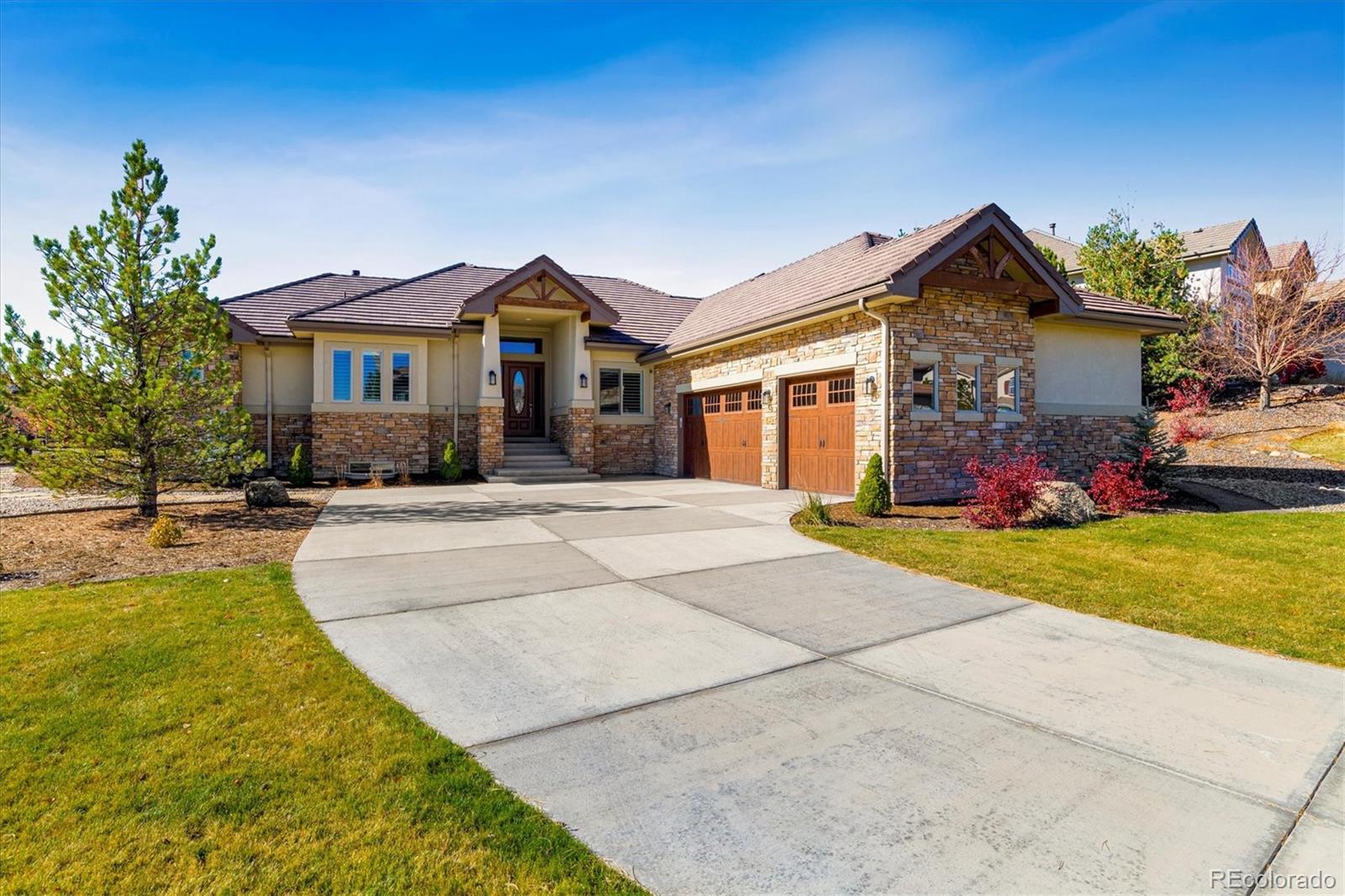 5561 Rim View Place Parker, CO 80134 - Photo 2 of 40 a front view of house with yard and trees around
