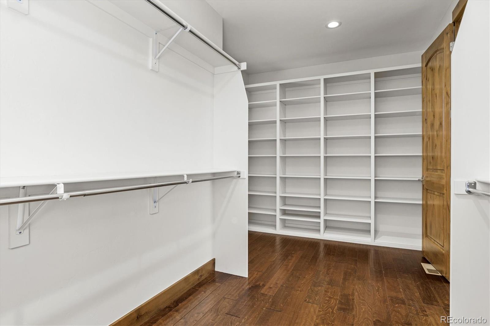 5561 Rim View Place Parker, CO 80134 - Photo 21 of 40 a view of walk in closet with empty racks