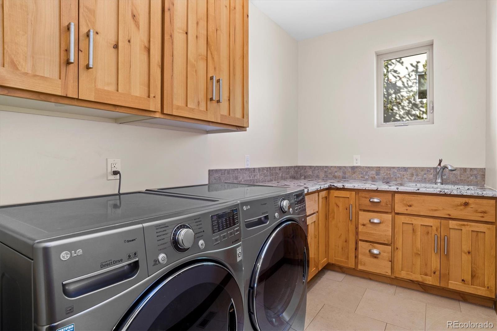 5561 Rim View Place Parker, CO 80134 - Photo 24 of 40 a utility room with dryer and washer