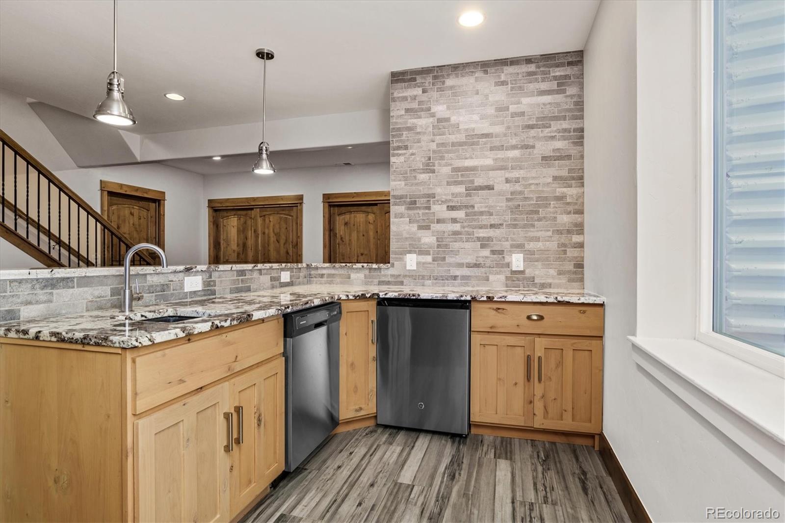 5561 Rim View Place Parker, CO 80134 - Photo 27 of 40 a kitchen with stainless steel appliances granite countertop a sink and a stove top oven