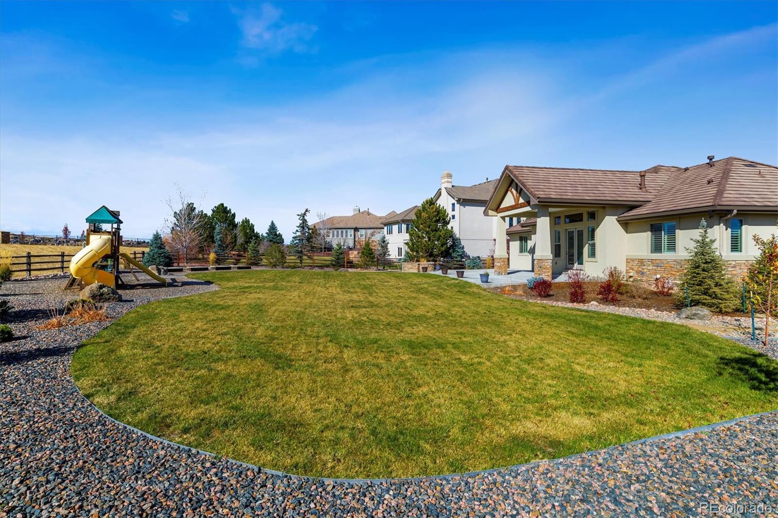 5561 Rim View Place Parker, CO 80134 - Photo 39 of 40 a view of a house with a big yard