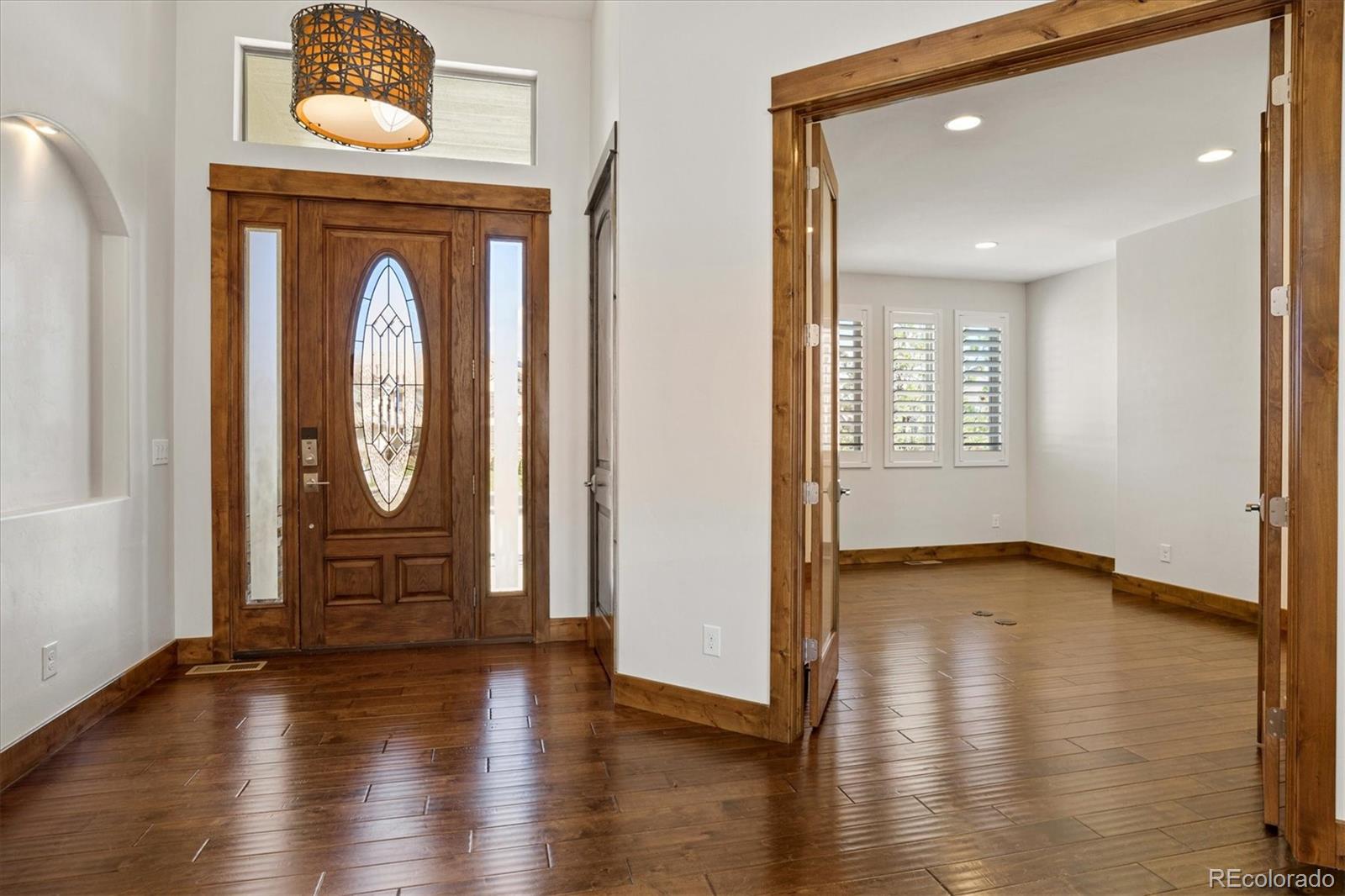 5561 Rim View Place Parker, CO 80134 - Photo 4 of 40 a view of livingroom with hallway and wooden floor