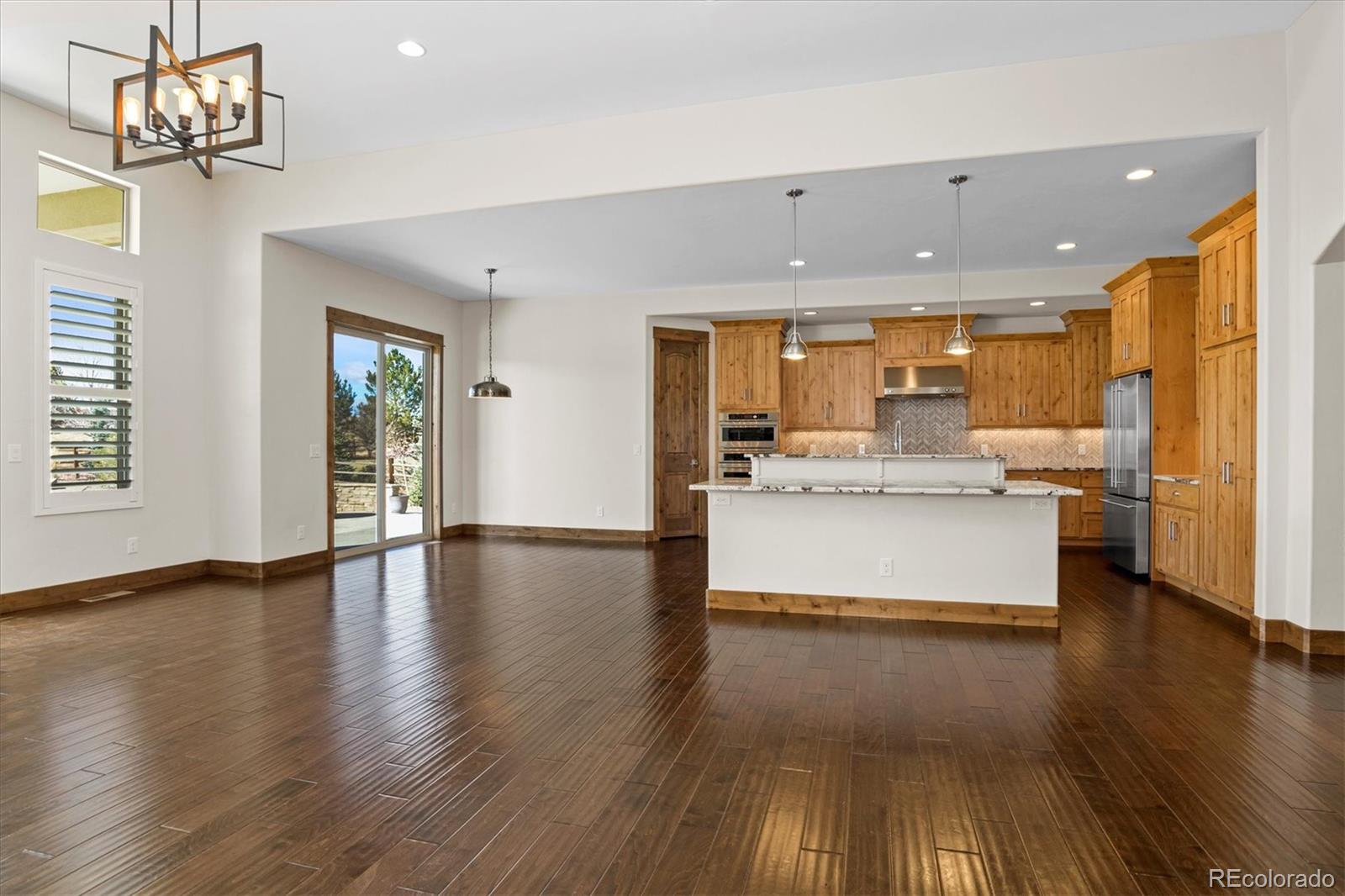 5561 Rim View Place Parker, CO 80134 - Photo 9 of 40 a view of kitchen with cabinets and wooden floor