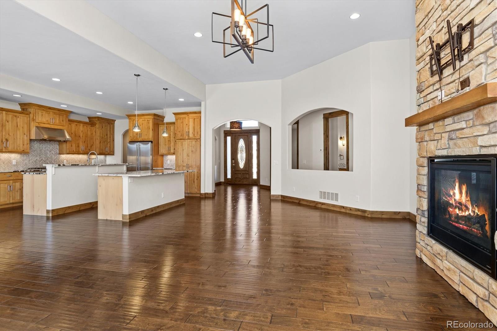 5561 Rim View Place Parker, CO 80134 - Photo 10 of 40 a view of a kitchen with furniture and wooden floor