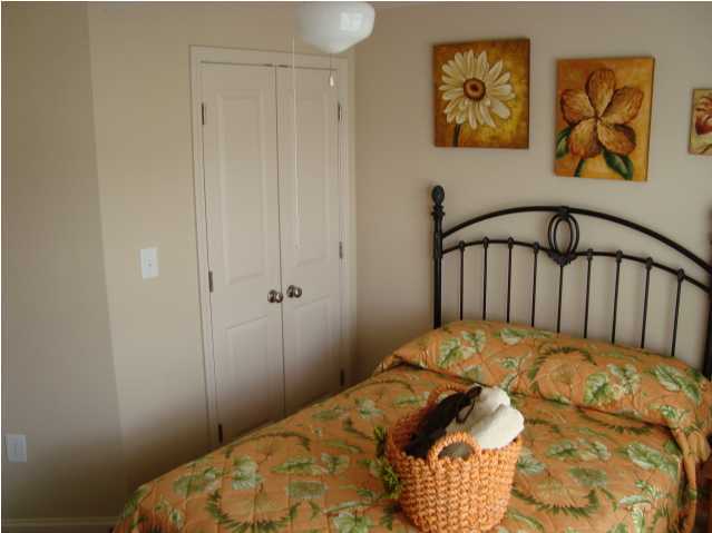 29 South Sand Palm Road, Unit 24 Freeport, FL 32439 - Photo 11 of 17 a bedroom with a bed and painting on the wall