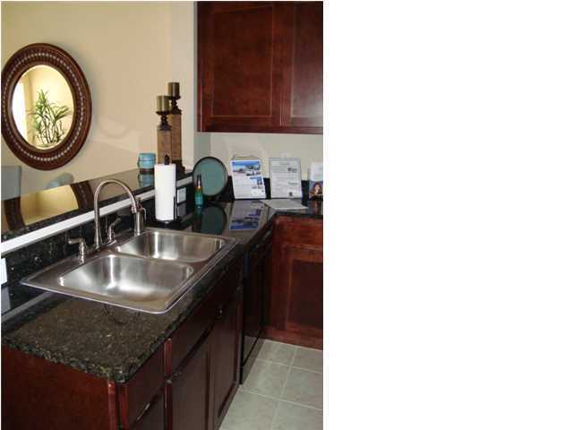 29 South Sand Palm Road, Unit 24 Freeport, FL 32439 - Photo 5 of 17 a kitchen with kitchen island granite countertop a sink and a stove
