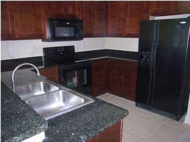 29 South Sand Palm Road, Unit 24 Freeport, FL 32439 - Photo 6 of 17 a kitchen with granite countertop stainless steel appliances and a sink