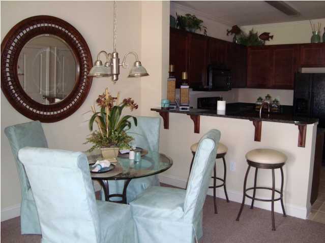 29 South Sand Palm Road, Unit 24 Freeport, FL 32439 - Photo 7 of 17 a dining room with furniture and wooden floor