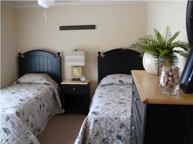 29 South Sand Palm Road, Unit 24 Freeport, FL 32439 - Photo 9 of 17 a bedroom with bed and mirror