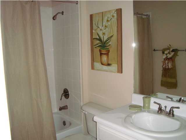 29 South Sand Palm Road, Unit 24 Freeport, FL 32439 - Photo 10 of 17 a bathroom with a granite countertop sink a toilet and shower