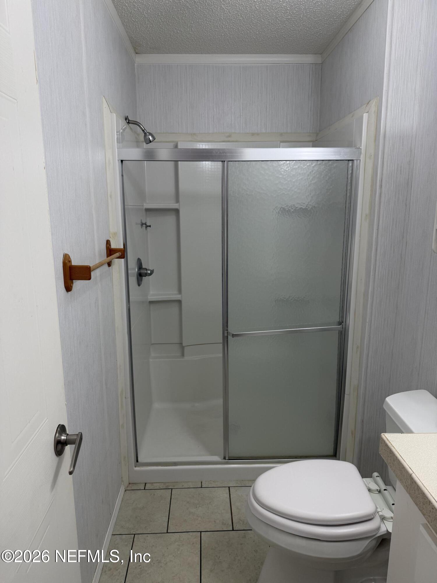 5597 Acadia Street Keystone Heights, FL 32656 - Photo 11 of 14 a bathroom with a toilet and a shower