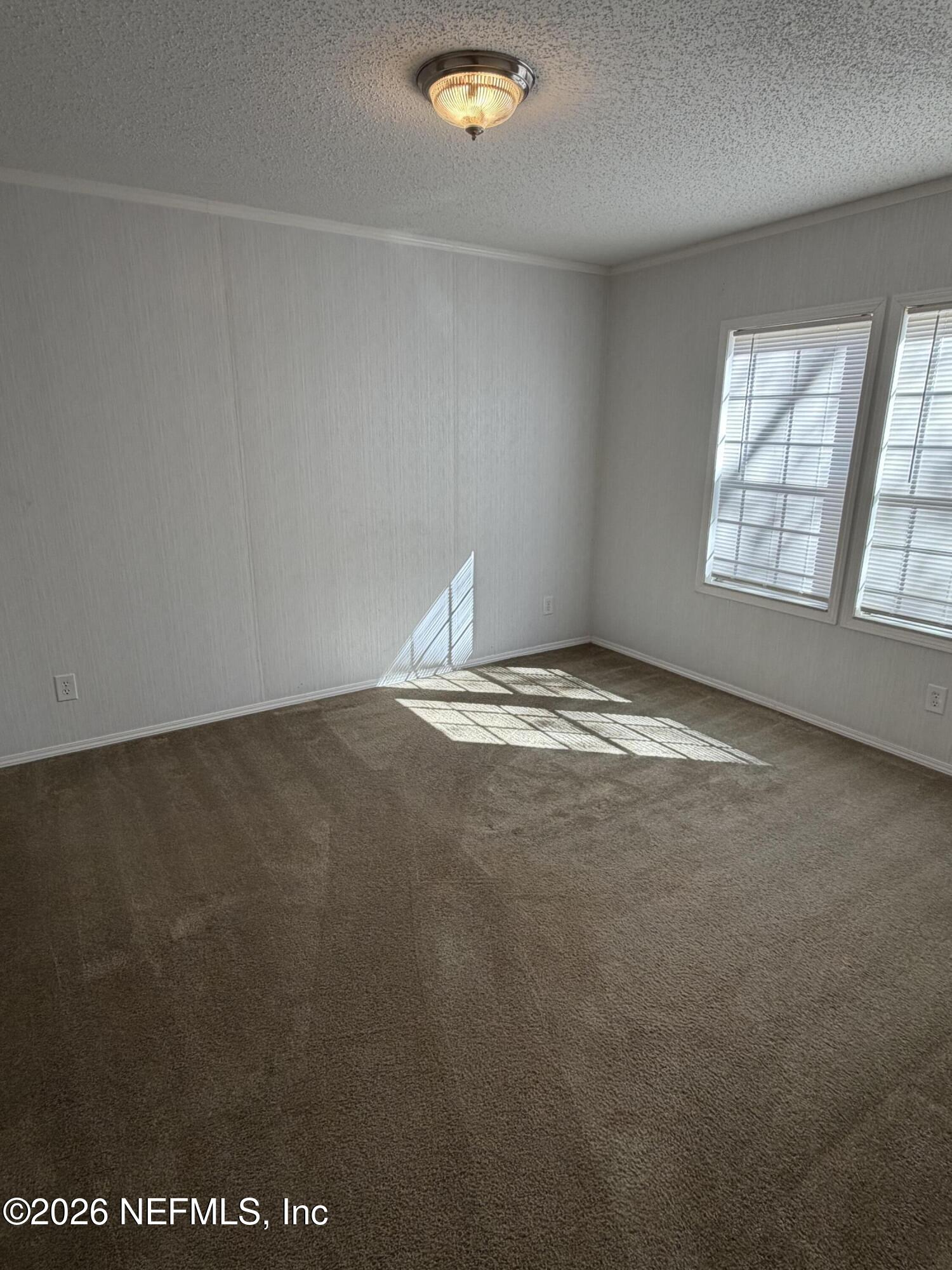 5597 Acadia Street Keystone Heights, FL 32656 - Photo 12 of 14 an empty room with windows
