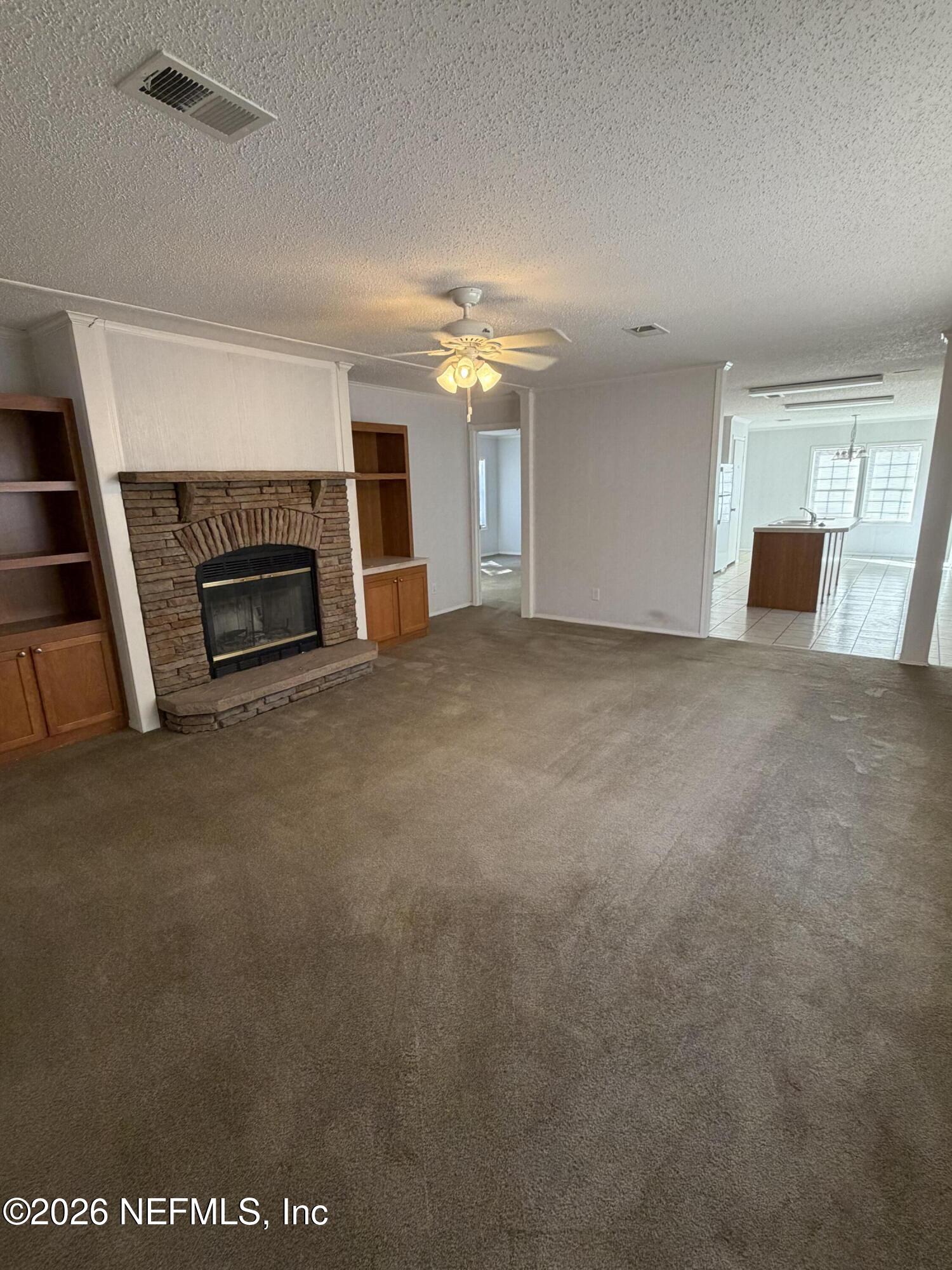 5597 Acadia Street Keystone Heights, FL 32656 - Photo 2 of 14 a view of a livingroom with a fireplace