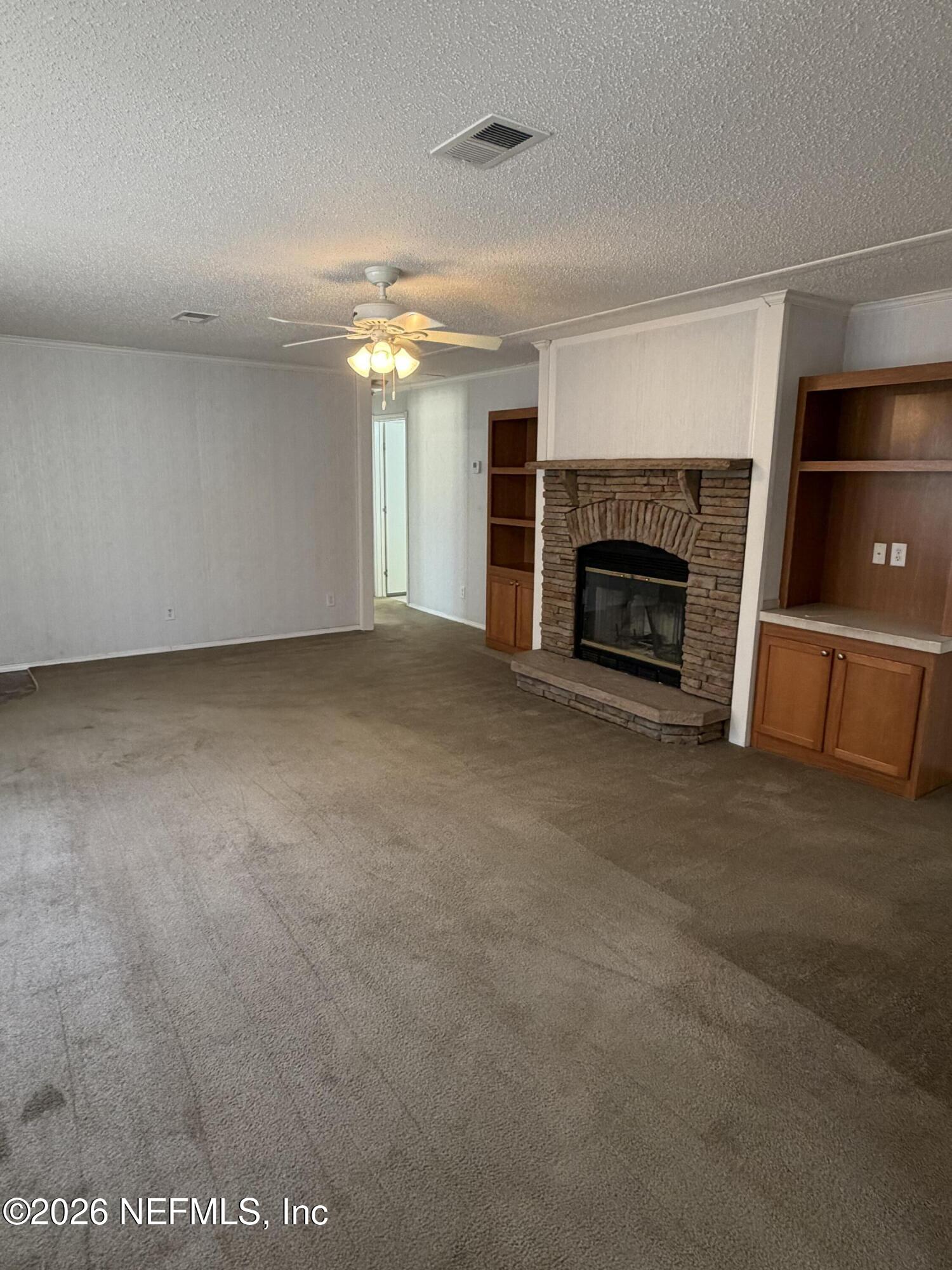 5597 Acadia Street Keystone Heights, FL 32656 - Photo 3 of 14 a view of an empty room with a fireplace