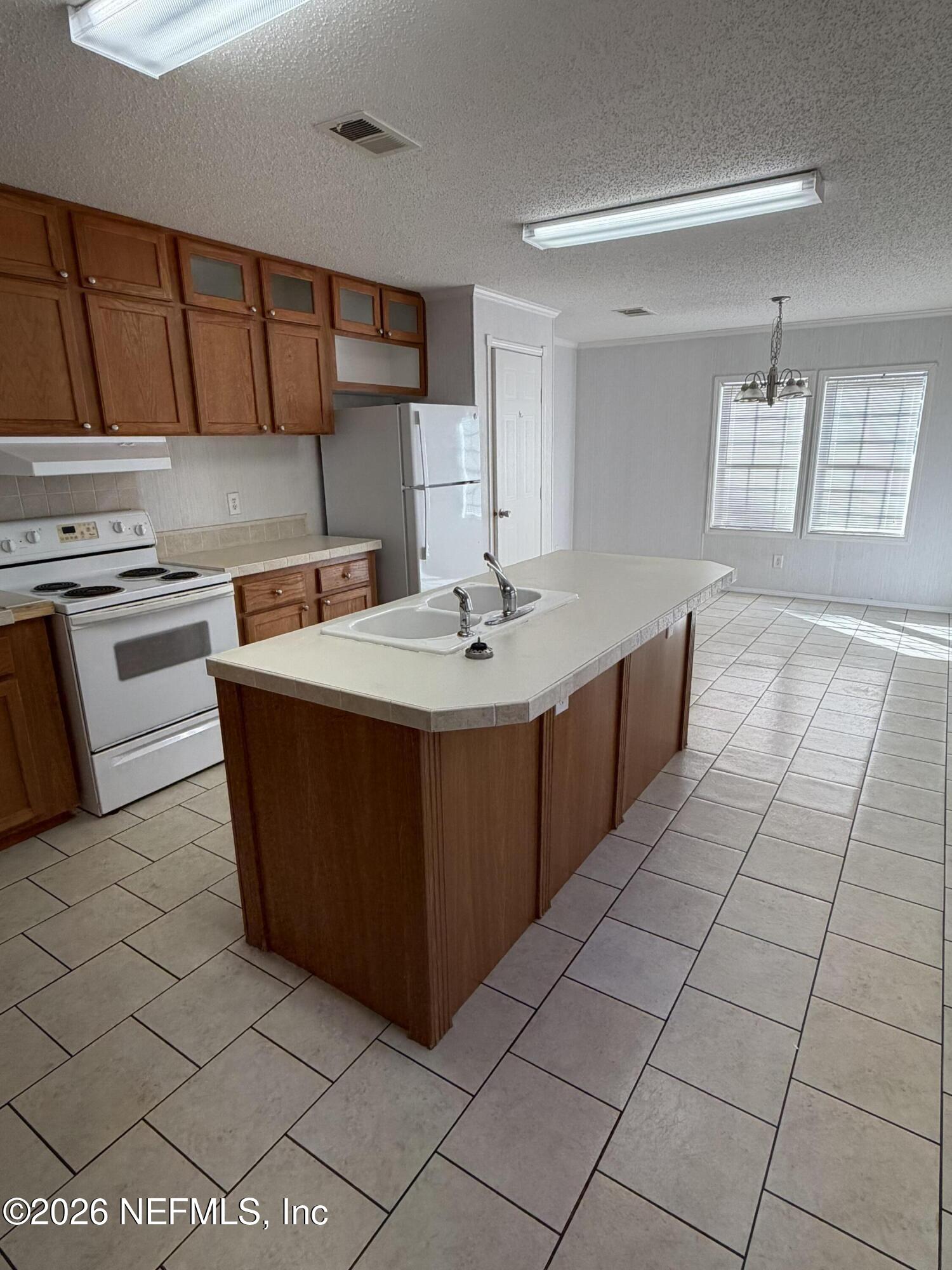 5597 Acadia Street Keystone Heights, FL 32656 - Photo 6 of 14 a kitchen with stainless steel appliances a sink stove and cabinets