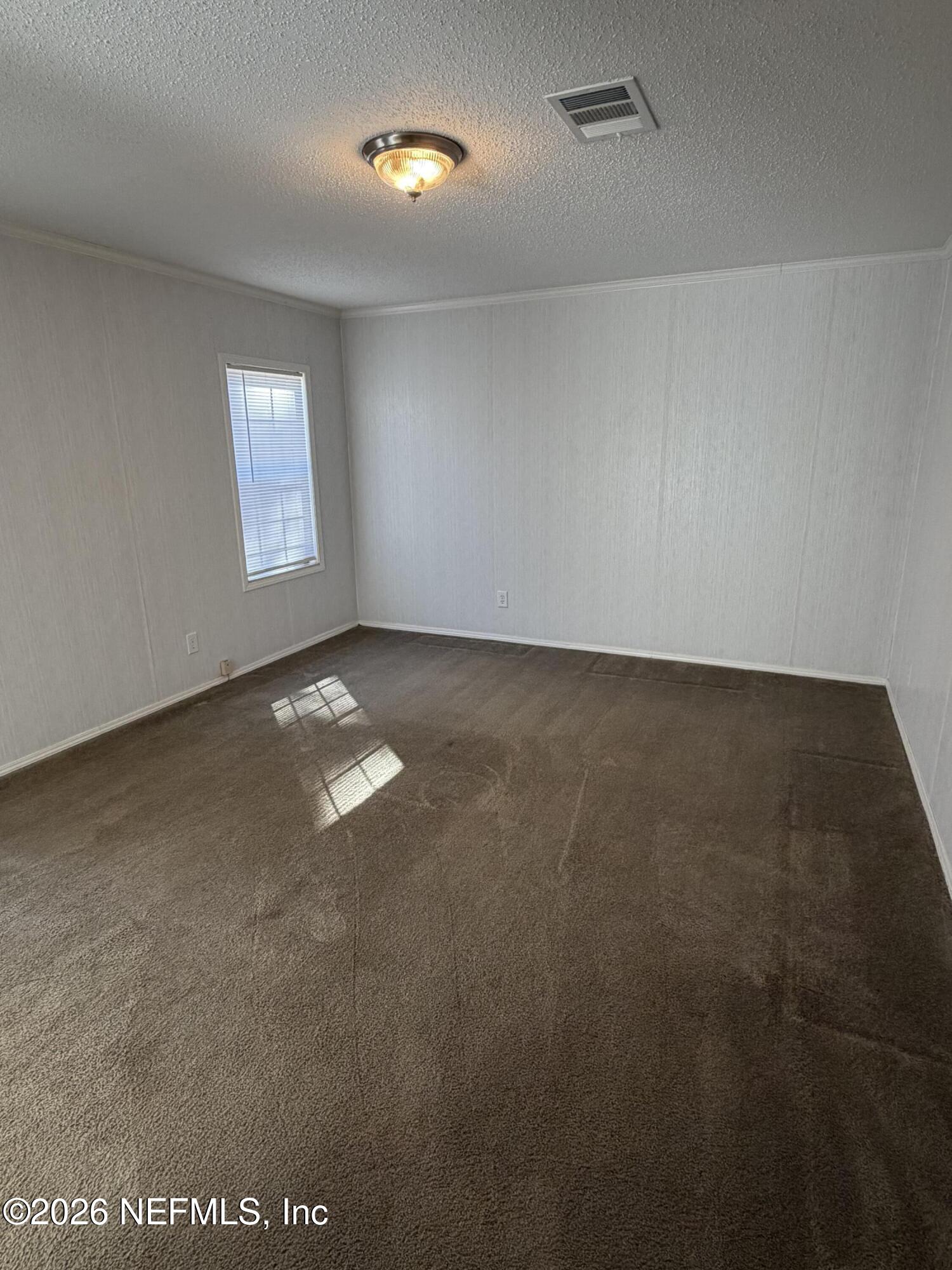 5597 Acadia Street Keystone Heights, FL 32656 - Photo 8 of 14 an empty room with windows