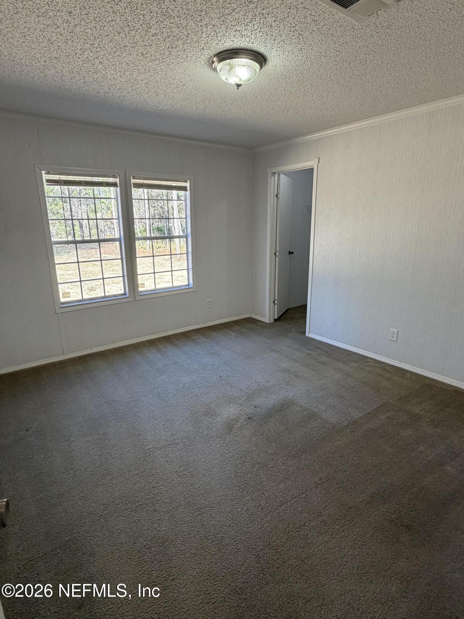 5597 Acadia Street Keystone Heights, FL 32656 - Photo 10 of 14 an empty room with a window