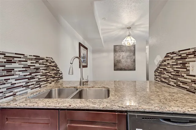 a kitchen with a sink and a stove