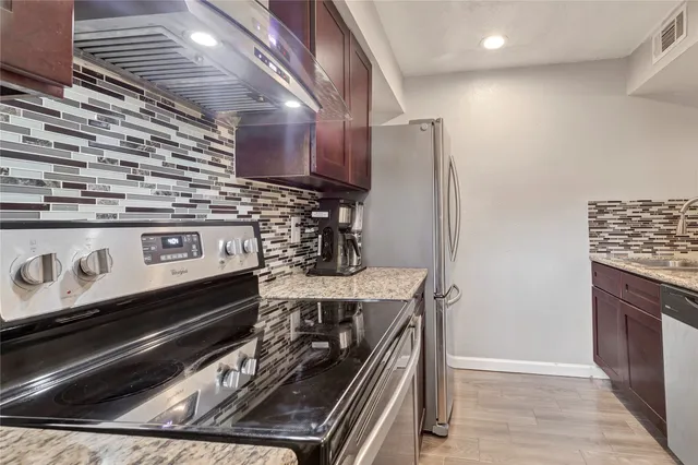 a stove top oven sitting inside of a kitchen