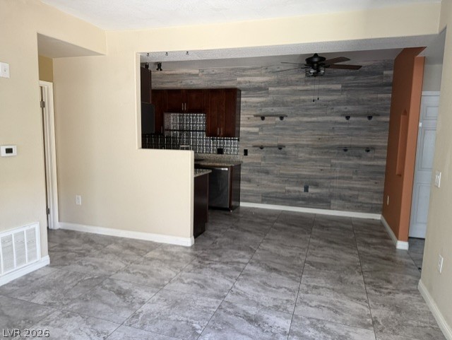 3318 North Decatur Boulevard, Unit 1163 Las Vegas, NV 89130 - Photo 13 of 35 The open-concept layout features durable tile flooring and a distinctive shiplap accent wall, creating a contemporary living space.