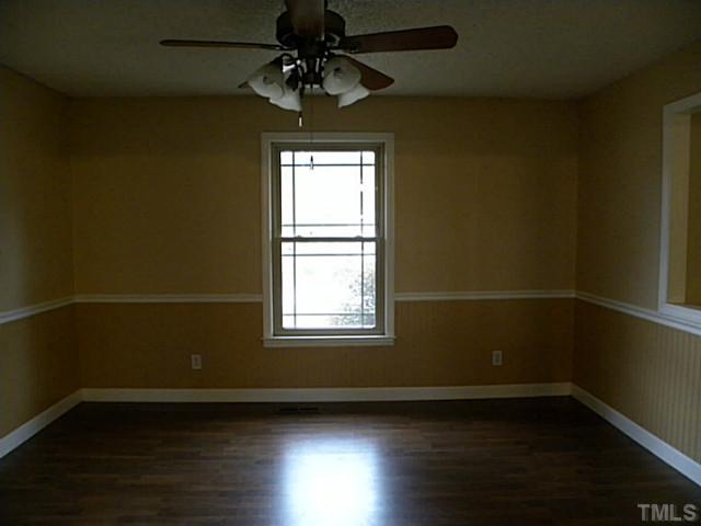 750 Greenleaf Road Angier, NC 27501 - Photo 4 of 10 an empty room with wooden floor fan and windows