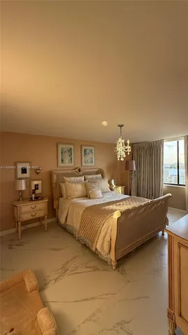 a spacious bedroom with a bed and window