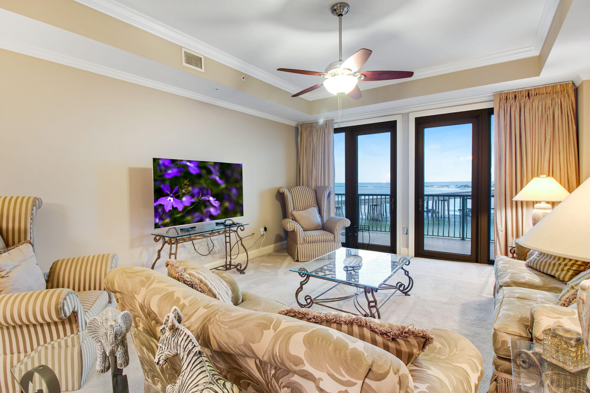 5 Calhoun Avenue, Unit 606 Destin, FL 32541 - Photo 18 of 37 a living room with furniture a dining table and a flat screen tv
