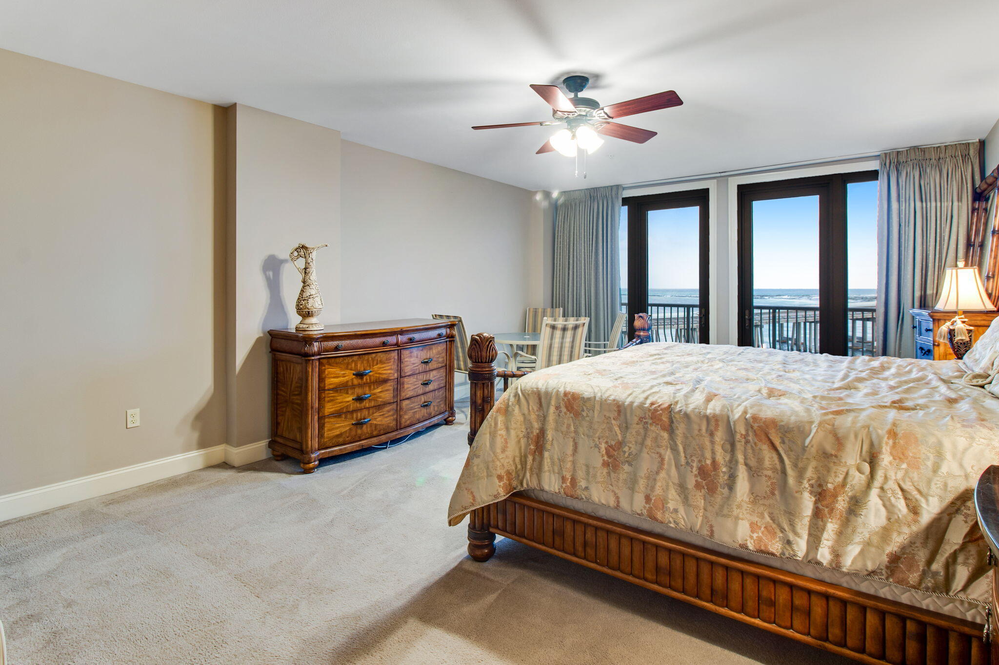 5 Calhoun Avenue, Unit 606 Destin, FL 32541 - Photo 26 of 37 a spacious bedroom with a bed a chandelier and windows