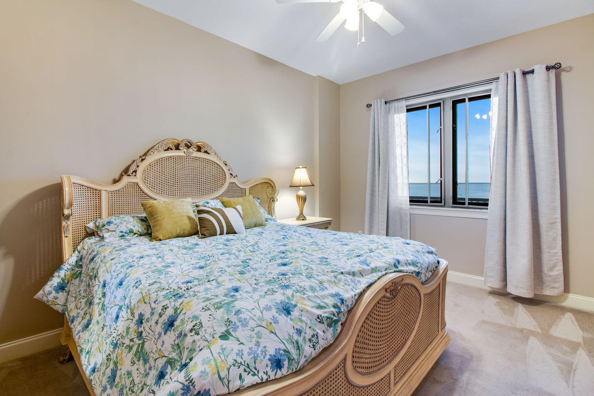 5 Calhoun Avenue, Unit 606 Destin, FL 32541 - Photo 30 of 37 a bedroom with a bed and a chandelier