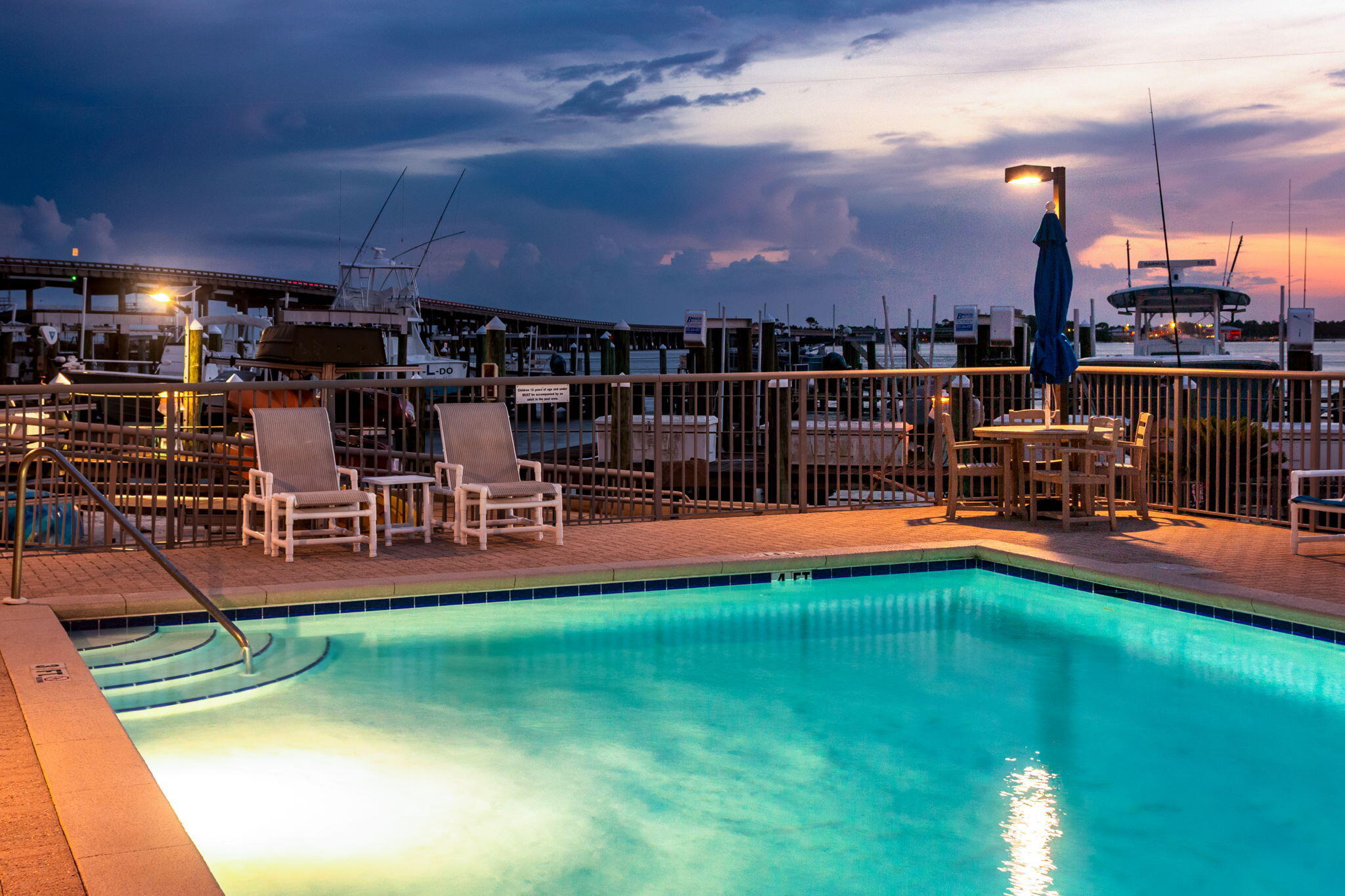 5 Calhoun Avenue, Unit 606 Destin, FL 32541 - Photo 36 of 37 a view of a chairs and table in backyard