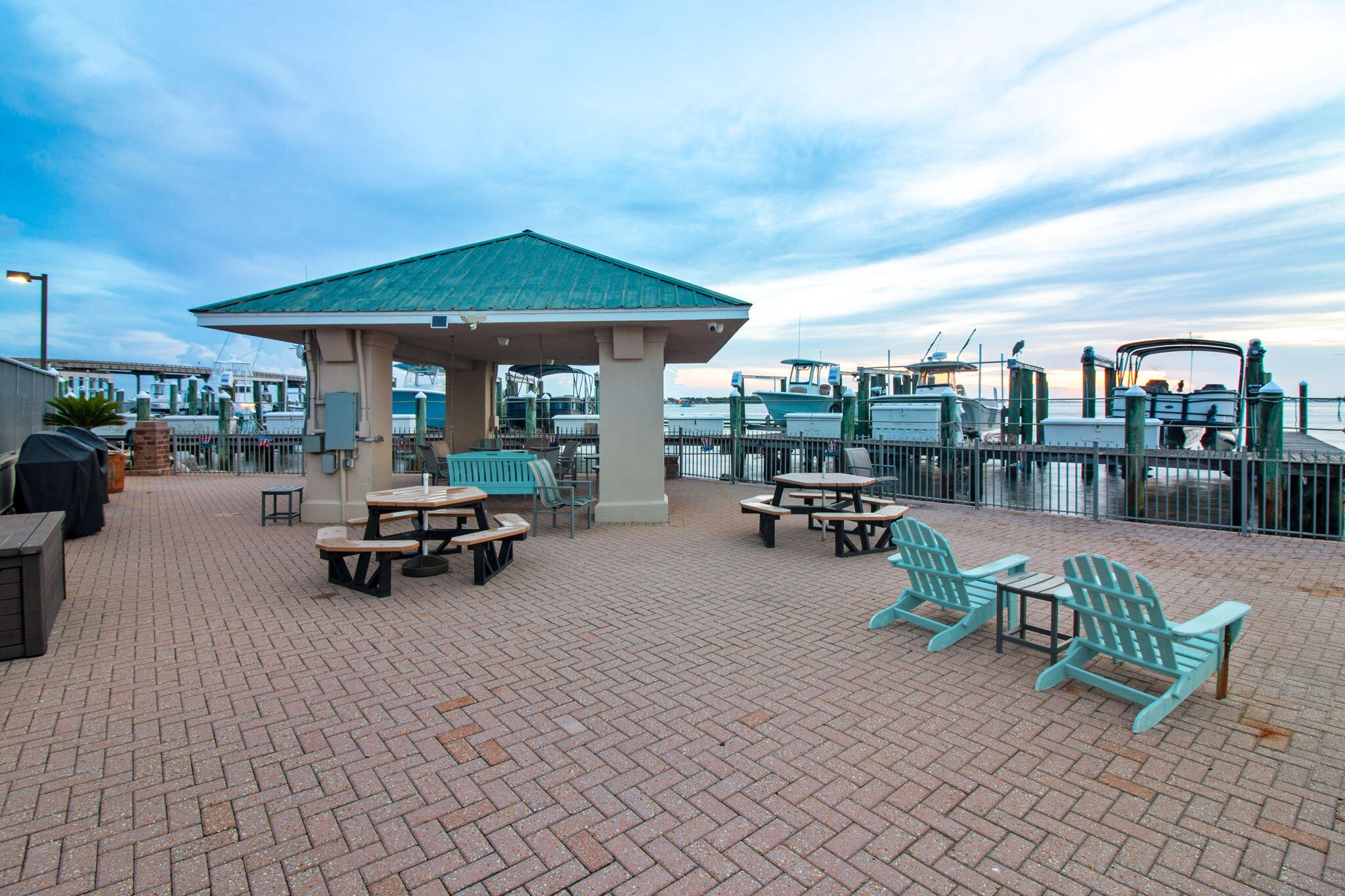 5 Calhoun Avenue, Unit 606 Destin, FL 32541 - Photo 7 of 37 a view of a patio with dining table and chairs under an umbrella
