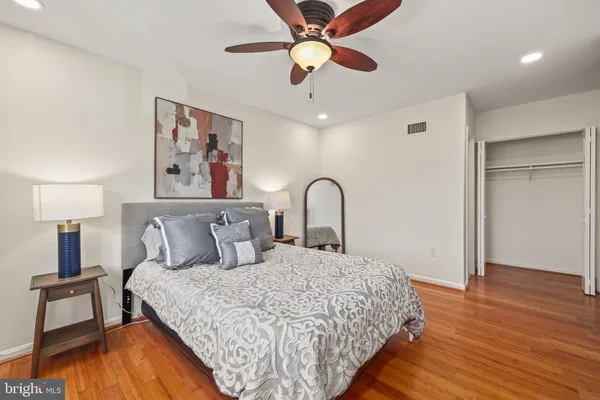 a bedroom with a large bed and a chandelier