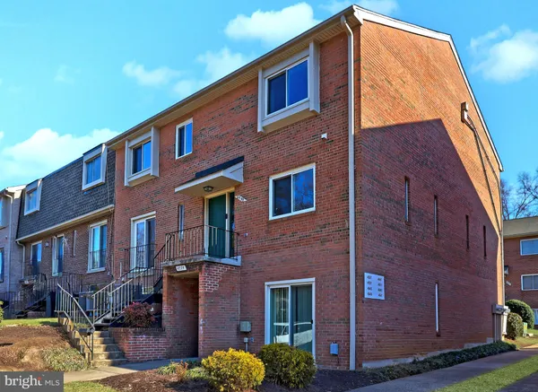 a front view of a building with a yard