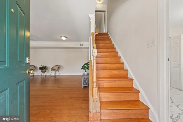 a view of entryway and hall with wooden floor