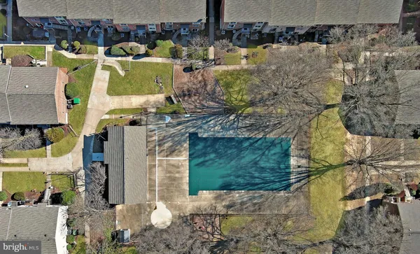 a buildings covered with tall trees