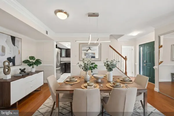 a view of a dining room with furniture and wooden floor