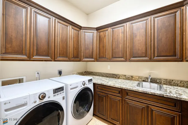 a view of a kitchen with sink and cabinets
