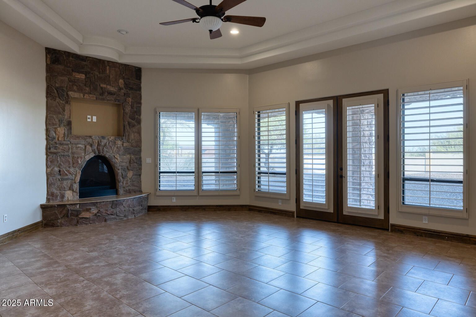 27115 North 137th Street Scottsdale, AZ 85262 - Photo 9 of 24 a view of an empty room with a fireplace and a window