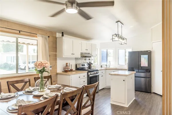 a kitchen with stainless steel appliances kitchen island granite countertop a sink and cabinets