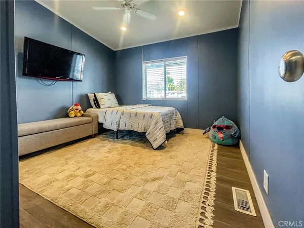 a bedroom with bed and flat screen tv