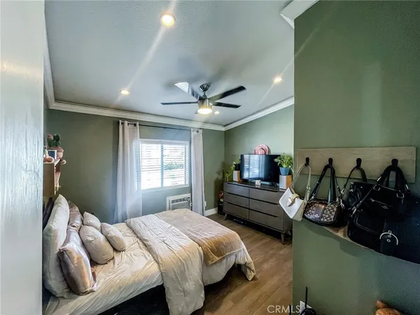 a bedroom with bed and a couch