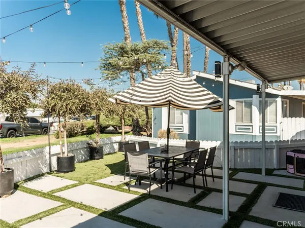 a view of a patio with table and chairs and potted plants