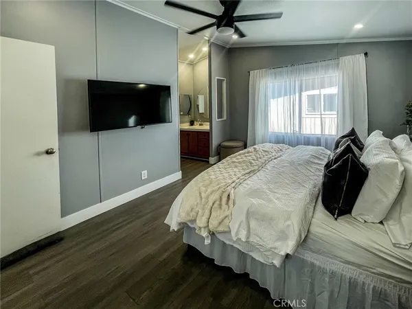 a bed sitting in a bedroom and tv