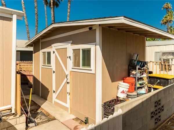 a blue and white house with outdoor seating
