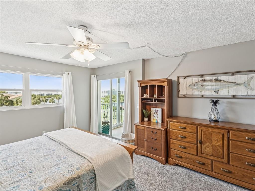10216 Regal Drive, Unit 409 Largo, FL 33774 - Photo 18 of 42 a bedroom with a bed dresser and a window